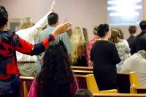People worshipping at Christian World Fellowship